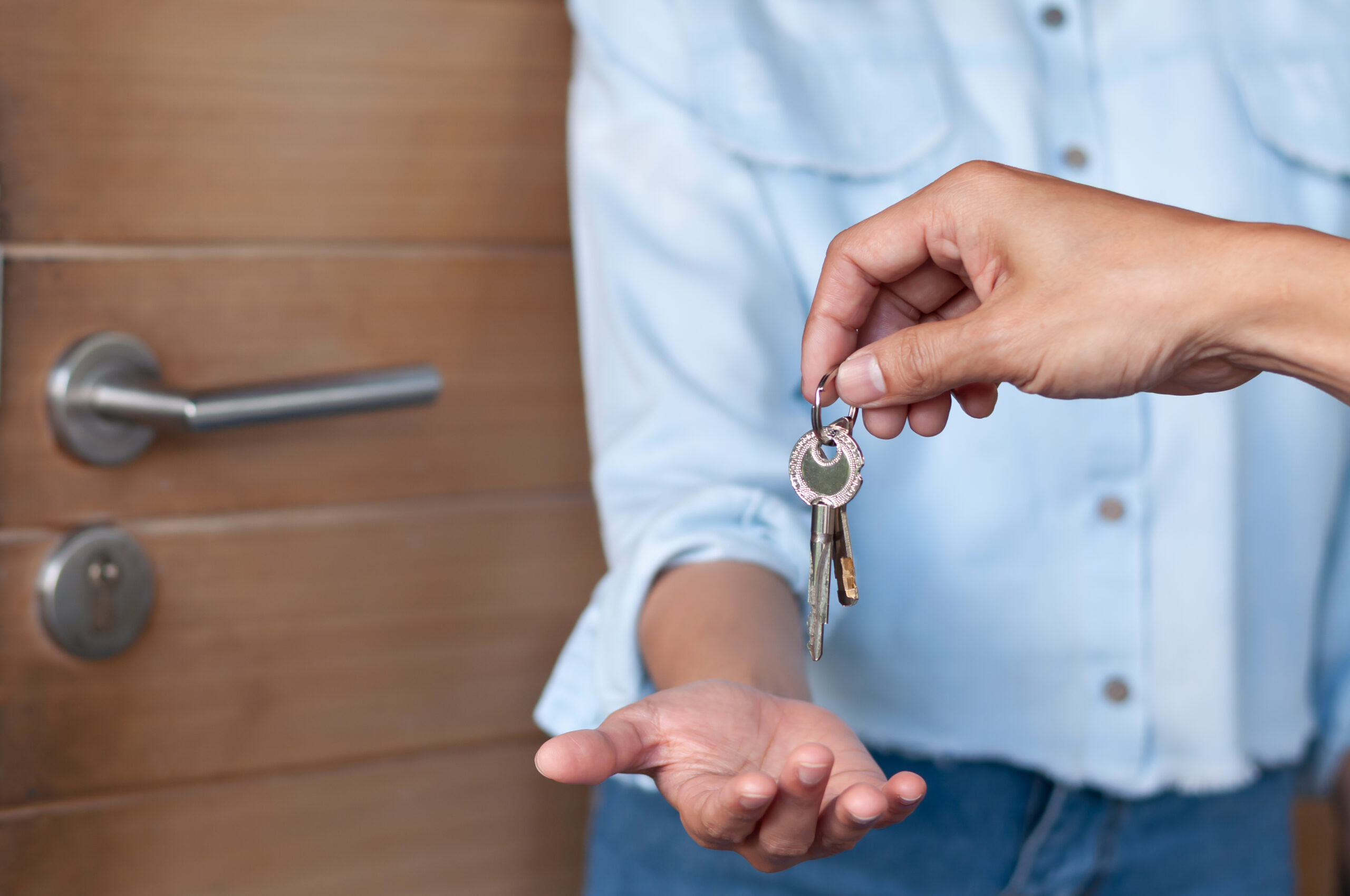 lease, rental and selling home. Real estate agent manager smile holding key for new owner. rent house, Sales, loan credit financial, insurance, Seller, dealer, installment,  buy, sell, move in